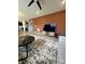 Open living space with comfortable seating and media center featuring a textured accent wall at 10218 Arctic Edge Dr, Indianapolis, IN 46259