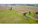 Wide aerial view showcasing property surrounded by agricultural fields on all sides, with homes nearby at 10500 S County Road 200 W, Muncie, IN 47302