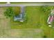 Aerial view of the property with the home having green roof surrounded by a green mowed lawn at 10500 S County Road 200 W, Muncie, IN 47302