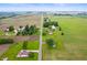 Wide aerial shot showcasing home surrounded by sprawling farm fields and other rural residences at 10500 S County Road 200 W, Muncie, IN 47302