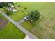 Aerial view of a home with a large tree and a lush, green lawn surrounded by farm land at 10500 S County Road 200 W, Muncie, IN 47302
