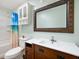 Bathroom featuring wood vanity, decorative mirror, and shower with a themed curtain at 10500 S County Road 200 W, Muncie, IN 47302