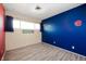Bedroom featuring wood-look flooring and large windows, with vibrant wall accents at 10500 S County Road 200 W, Muncie, IN 47302