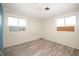 Cozy bedroom with neutral walls, two windows, and wood-look flooring at 10500 S County Road 200 W, Muncie, IN 47302