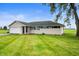 Inviting home with a large front yard and attached garage, surrounded by greenery at 10500 S County Road 200 W, Muncie, IN 47302