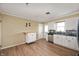 Well-lit kitchen with white cabinets, stainless steel appliances, and wood-look flooring at 10500 S County Road 200 W, Muncie, IN 47302