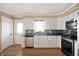 Bright kitchen features white cabinetry, stainless steel appliances, and a window view at 10500 S County Road 200 W, Muncie, IN 47302