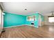 Open living space with unique accent wall, wood floors, and ample natural light at 10500 S County Road 200 W, Muncie, IN 47302