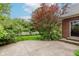 Enjoy outdoor living on this home's patio surrounded by lush landscaping and mature trees at 11074 Galley Way, Fishers, IN 46040