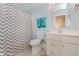 Clean bathroom with gray and white patterned shower curtain, and a white cabinet at 11074 Galley Way, Fishers, IN 46040