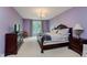 Primary bedroom with elegant furnishings, soft lighting, and hardwood floors at 11074 Galley Way, Fishers, IN 46040