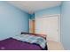 This cozy bedroom features light blue walls, carpet, and a closet with sliding doors at 11074 Galley Way, Fishers, IN 46040