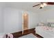 Bright bedroom with a queen bed, dark wood flooring, ceiling fan and walk-in closet at 11074 Galley Way, Fishers, IN 46040