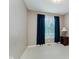 This empty bedroom has neutral walls, carpet, and bright window with dark blue curtains at 11074 Galley Way, Fishers, IN 46040