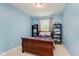 This is a cozy bedroom with light blue walls, carpet and a bright window at 11074 Galley Way, Fishers, IN 46040