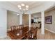 Formal dining room features decorative columns, modern chandelier, and hardwood floors at 11074 Galley Way, Fishers, IN 46040
