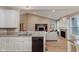 Bright kitchen and living room with hardwood floors and modern black appliances at 11074 Galley Way, Fishers, IN 46040