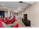 Spacious living room with bright red sofa, recessed lighting and light colored flooring and walls at 11074 Galley Way, Fishers, IN 46040