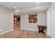 Open-concept living space with a passthrough and light colored flooring, walls, and recessed lighting at 11074 Galley Way, Fishers, IN 46040