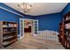 Inviting living room with built-in bookcases, couch, recessed lighting, and french doors to another room at 11074 Galley Way, Fishers, IN 46040