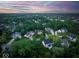 Stunning aerial view of a lush, green neighborhood with upscale homes and colorful, dynamic sunset sky at 12450 Petalon Trce, Fishers, IN 46037