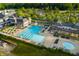 Aerial view of swimming pool with lounge chairs, umbrellas, and a building at 12450 Petalon Trce, Fishers, IN 46037
