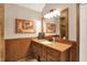 Bathroom featuring a wood vanity with a large mirror, lighting, and tiled accents at 12450 Petalon Trce, Fishers, IN 46037