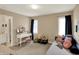 Bedroom featuring a vanity and seat next to a cushioned sofa and black out curtains at 12450 Petalon Trce, Fishers, IN 46037