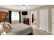 Neutral bedroom offering a large window with dark curtains and an entry to the bathroom at 12450 Petalon Trce, Fishers, IN 46037