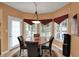 Cozy breakfast nook with a round table, four chairs, large windows and access to the patio at 12450 Petalon Trce, Fishers, IN 46037