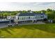 Aerial view of clubhouse with a large grassy area and golf carts parked in front at 12450 Petalon Trce, Fishers, IN 46037