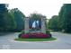 Stone entrance to The Hawthorns neighborhood with manicured landscaping and mature trees at 12450 Petalon Trce, Fishers, IN 46037