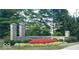 Stone entrance to Hamilton Proper neighborhood with manicured landscaping and lush trees at 12450 Petalon Trce, Fishers, IN 46037