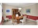 A dining room features wood table, chairs, and china cabinet with decorative items at 12450 Petalon Trce, Fishers, IN 46037