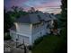 Aerial view of a two-story home featuring a large backyard, garage, and outdoor deck at 12450 Petalon Trce, Fishers, IN 46037