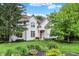 Charming white two-story home with manicured landscaping and inviting front porch at 12450 Petalon Trce, Fishers, IN 46037