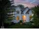 Charming white two-story home with manicured landscaping and inviting front porch at 12450 Petalon Trce, Fishers, IN 46037
