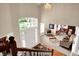 Grand two-story foyer with hardwood flooring, a large front door, and open views into the living spaces at 12450 Petalon Trce, Fishers, IN 46037