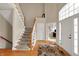 Inviting foyer with wood floors, staircase and front door at 12450 Petalon Trce, Fishers, IN 46037