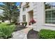 Welcoming front porch with decorative hanging flowers and manicured landscaping at 12450 Petalon Trce, Fishers, IN 46037