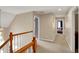 Upstairs hallway with carpet, wooden railings and views of the bedrooms at 12450 Petalon Trce, Fishers, IN 46037