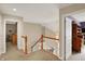 Upstairs hallway with carpet flooring, wood railing and view into the bedrooms at 12450 Petalon Trce, Fishers, IN 46037