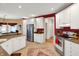 A stylish kitchen offers stainless steel appliances, granite counters, and bright cabinetry at 12450 Petalon Trce, Fishers, IN 46037