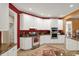 Bright kitchen featuring white cabinetry, stainless steel appliances, granite countertops and a decorative rug at 12450 Petalon Trce, Fishers, IN 46037