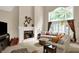 The living room features fireplace, mantle, large windows, and comfortable seating at 12450 Petalon Trce, Fishers, IN 46037