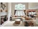 This living room with fireplace flows to the dining room and kitchen at 12450 Petalon Trce, Fishers, IN 46037