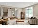 The bright living room has large windows and a view of the front entry and staircase at 12450 Petalon Trce, Fishers, IN 46037