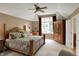 Spacious main bedroom with a ceiling fan, large window and a seating area at 12450 Petalon Trce, Fishers, IN 46037