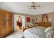 Spacious main bedroom with a ceiling fan, adjacent to the main bathroom at 12450 Petalon Trce, Fishers, IN 46037