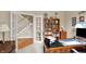 Home office with lots of storage and a view of the staircase through the French doors at 12450 Petalon Trce, Fishers, IN 46037